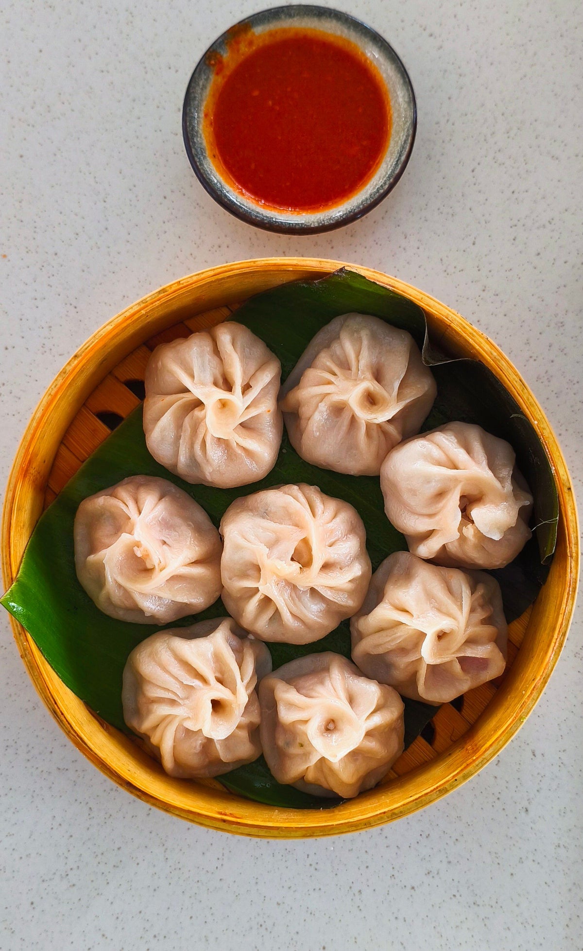 Steamed momos with chilli sauce